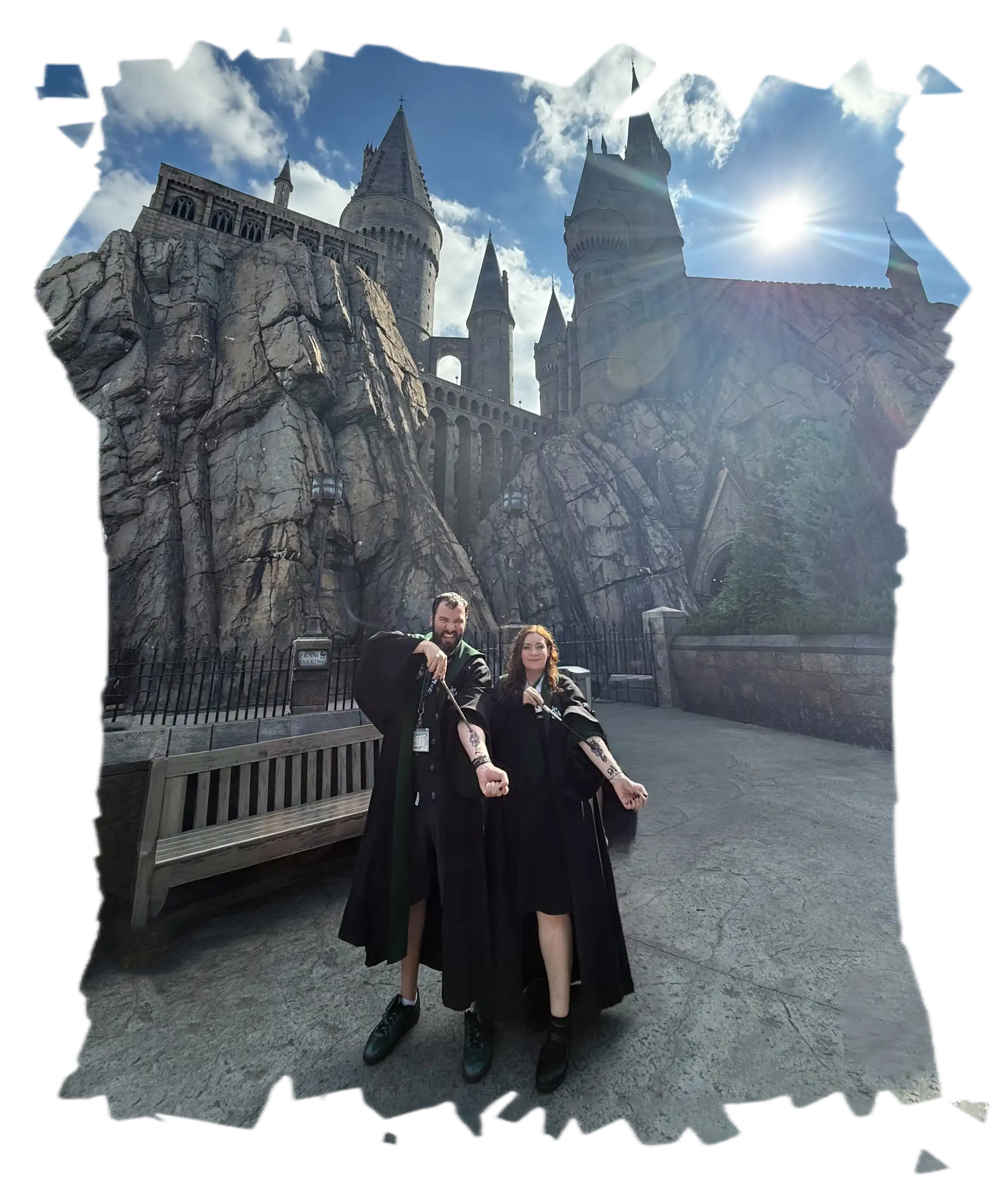 Me and my fiancée Alice posing proudly with matching dark mark tattoos in front of the Hogwarts castle at Universal Orlando